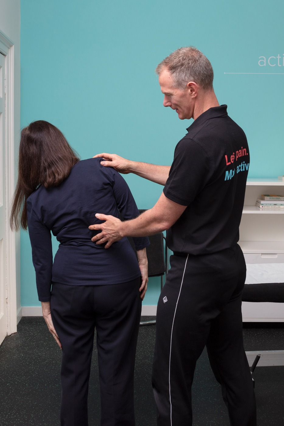 Osteopath Gavin Routledge standing exam sidebending from back